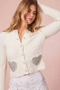 Cream textured wool-blend cardigan with button front and heart sequin chest pockets