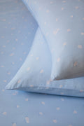 Blue fabric with white floral patterns, resembling a polka dot pattern.
