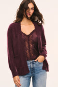Merlot cardigan worn open with V-neckline, button front, and two front pockets