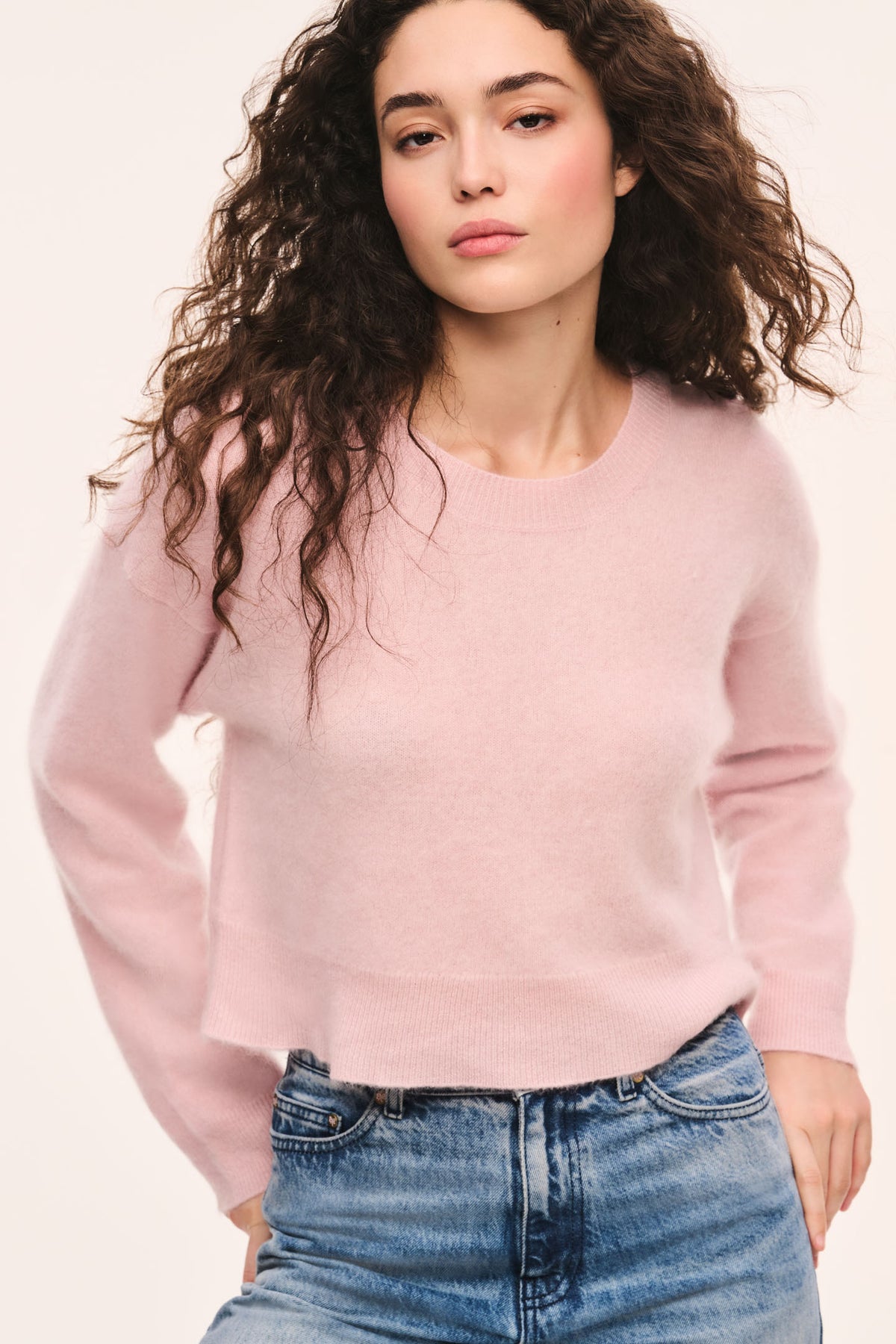 Pink crewneck knit pullover with long sleeves and ribbed cuffs