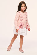 Girls' pink cable-knit cardigan with large ribbon threaded through and bow at hem