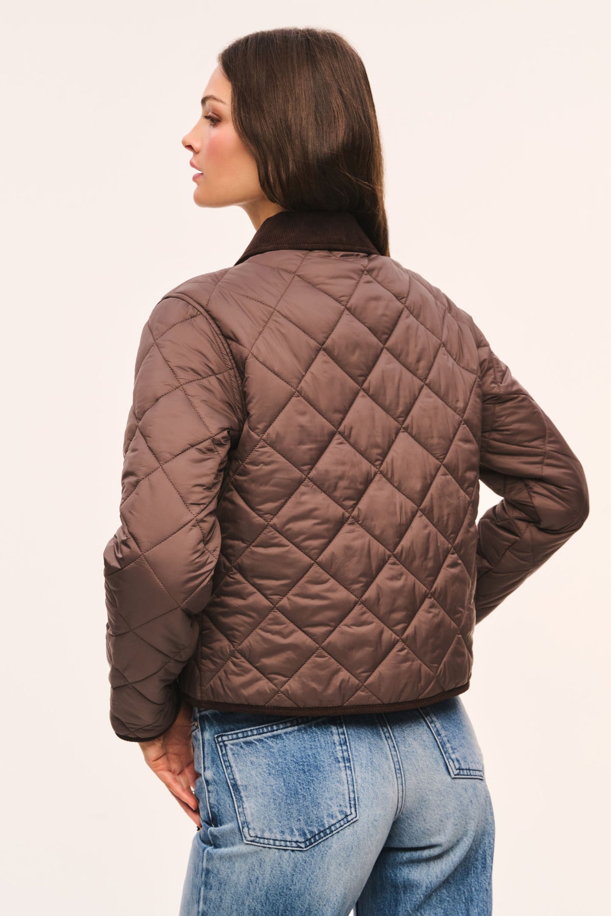 Back view of brown quilted jacket with dark brown corduroy collar and corduroy trim