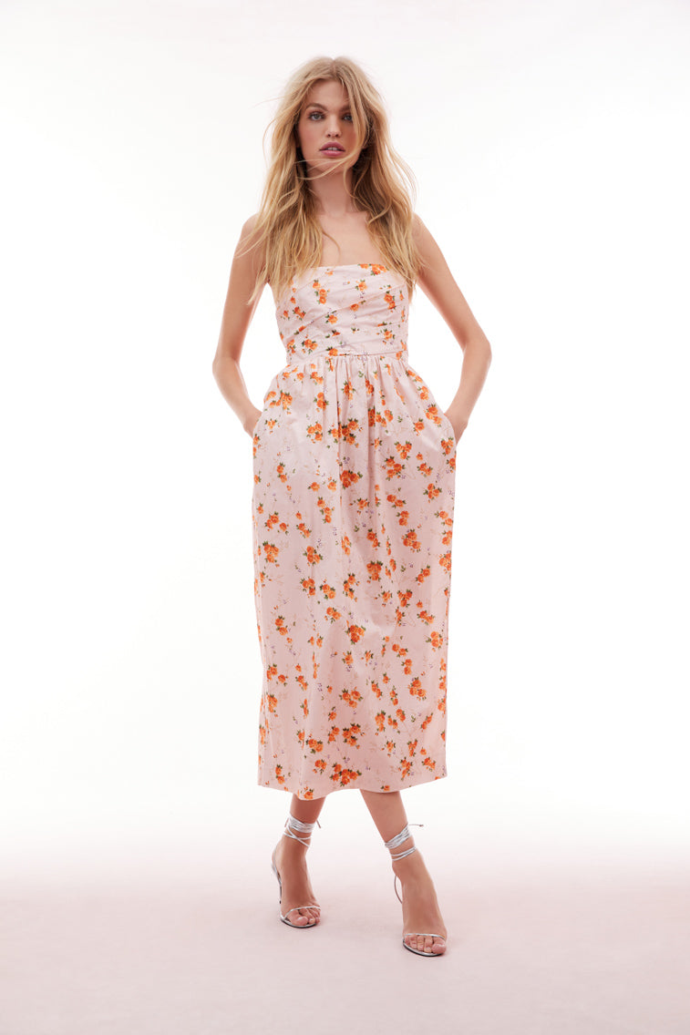 Floral printed midi dress with a tulip silhouette featuring a skirt slightly wider at the hips than tapers down toward the floor. The bodice has an asymmetrical draping, a structural inside with boning for support and a flattering fit with a cinched waist. 
