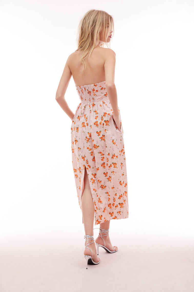 Floral printed midi dress with a tulip silhouette featuring a skirt slightly wider at the hips than tapers down toward the floor. The bodice has an asymmetrical draping, a structural inside with boning for support and a flattering fit with a cinched waist.