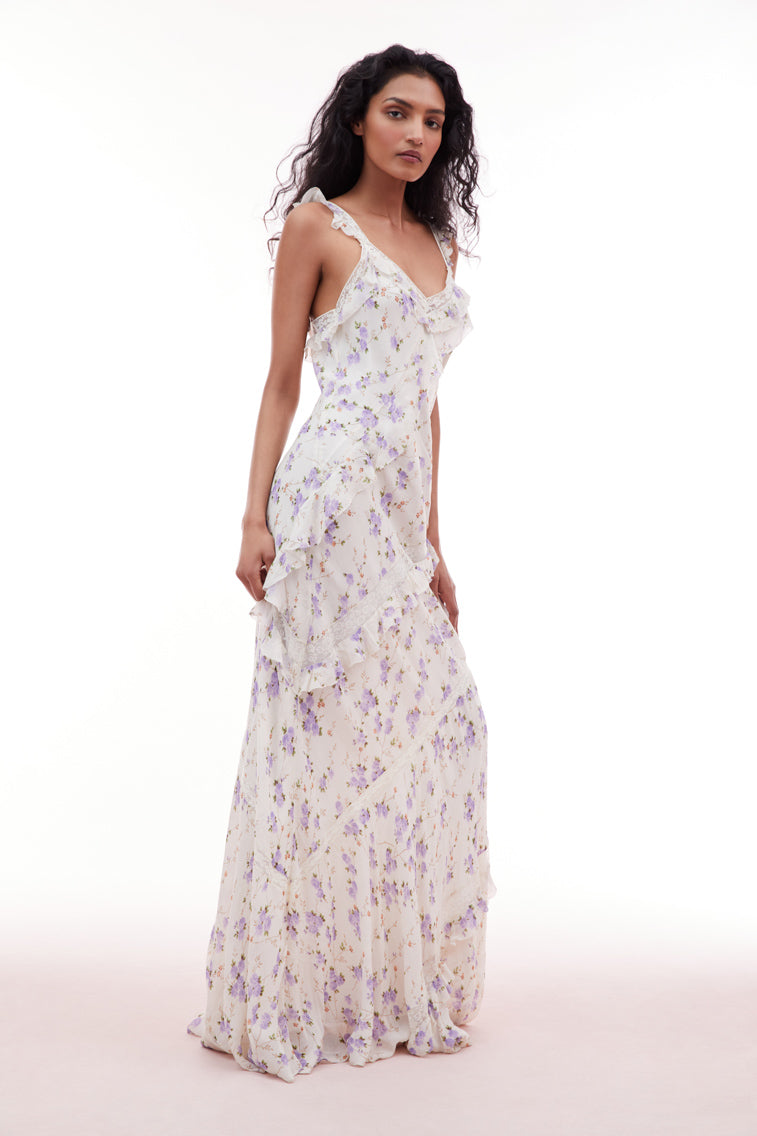 Floral printed maxi dress with lace straps, flutter sleeves, and ruffle details all over.