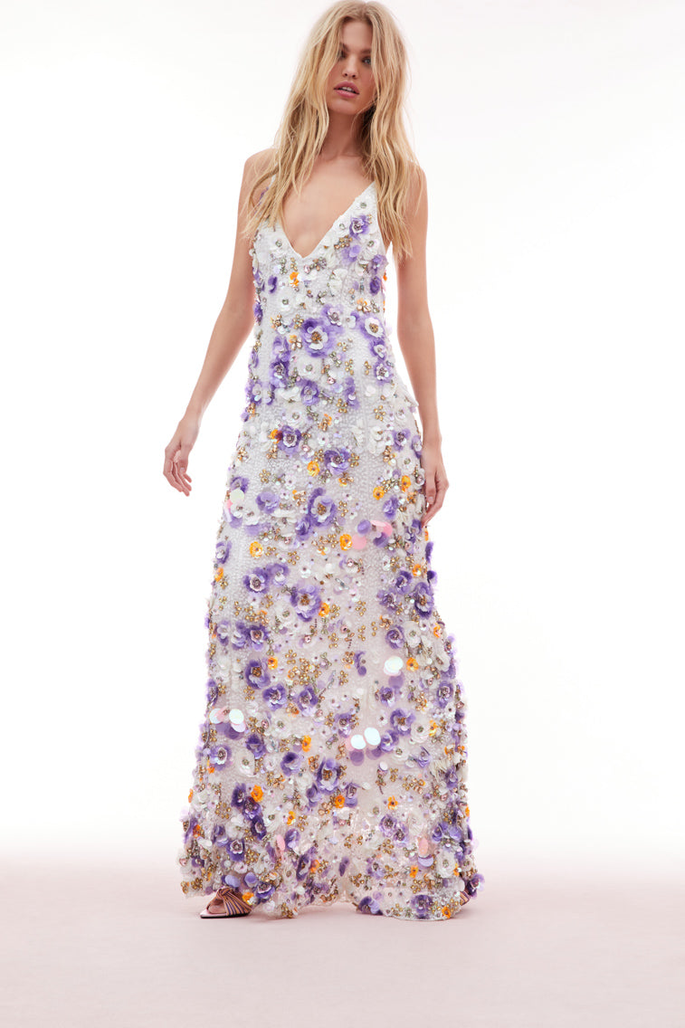 Maxi dress with sequin embroidered mesh on top, lilac and tangerine payettes with sequins, rhinestones, and crystals sprinkled throughout. The piece begins with a deep v-neckline and delicate spaghetti straps before falling to the bodice which features an internal corset with a shelf bra.