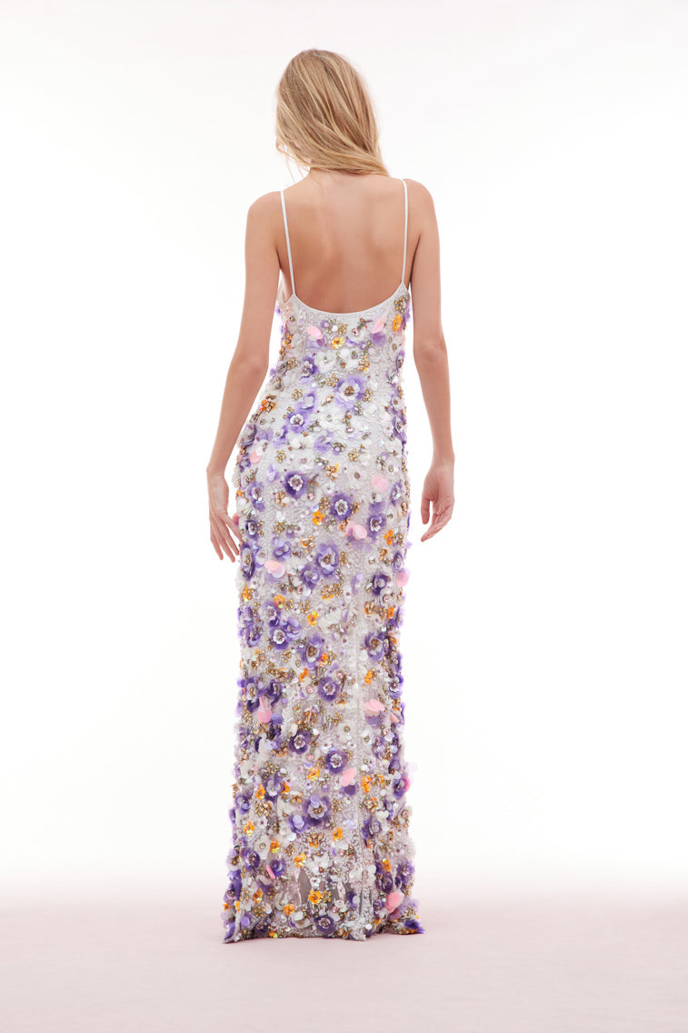 Maxi dress with sequin embroidered mesh on top, lilac and tangerine payettes with sequins, rhinestones, and crystals sprinkled throughout. The piece begins with a deep v-neckline and delicate spaghetti straps before falling to the bodice which features an internal corset with a shelf bra.