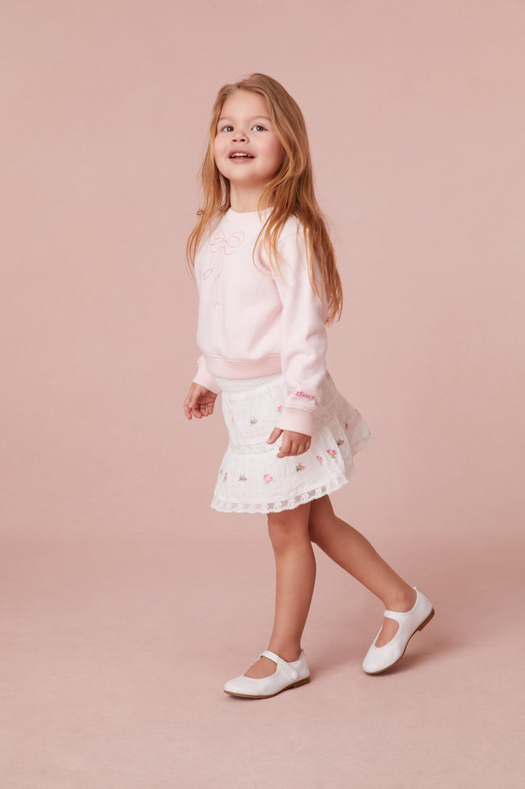 Girls skirt embroidered with small rosebuds all over, an elasticated waistband and lace details all over.