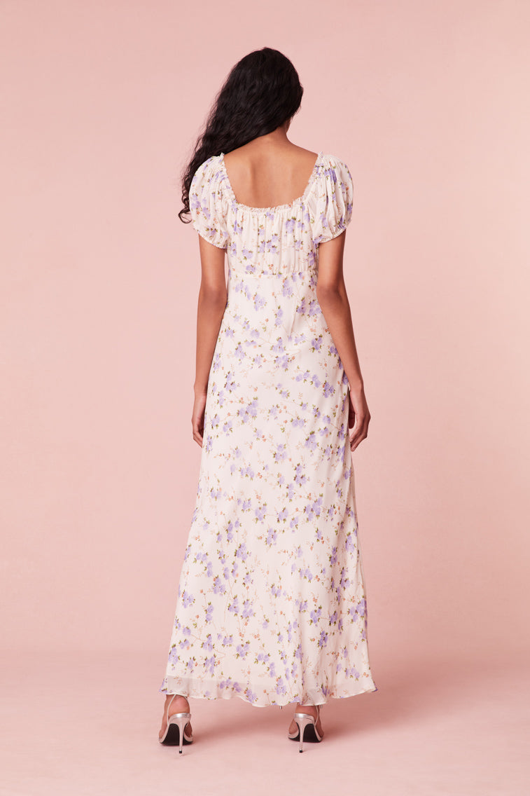 Floral printed maxi dress with short puff sleeves, a slightly square neckline with ruching at center front, and a breezy maxi skirt.