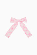 Pink and white patterned bow on a white background