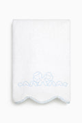 White towel with blue embroidery on a white background