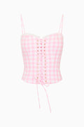 Pink gingham corset top on a white background