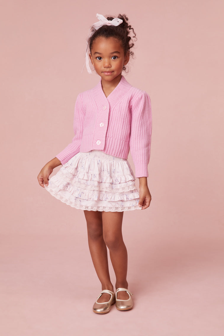 Mini skirt with a wide smocked waistband and two shirred tiers with ruffle details.