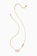 Gold necklace with a pink pendant on a white background