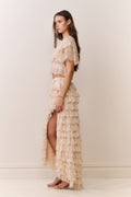Woman wearing a beige lace set with a plain background