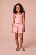 Girls top with tiny flutter sleeves, ruffle smocking all over, and a dainty ruffle peplum hem.