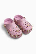 Pink croc clogs with decorative elements on a white background