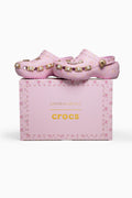 Pink crocs with embellishments on a pink 'crocs' box