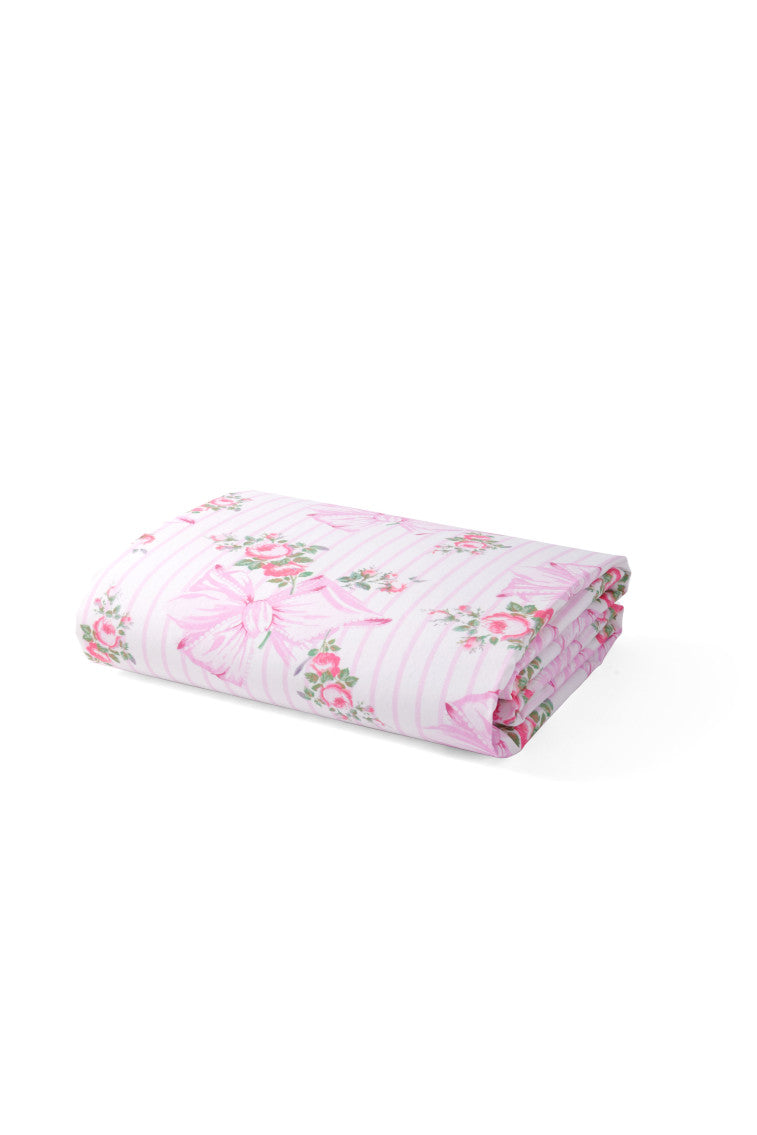 Crib sheet featuring a pink bow and floral print