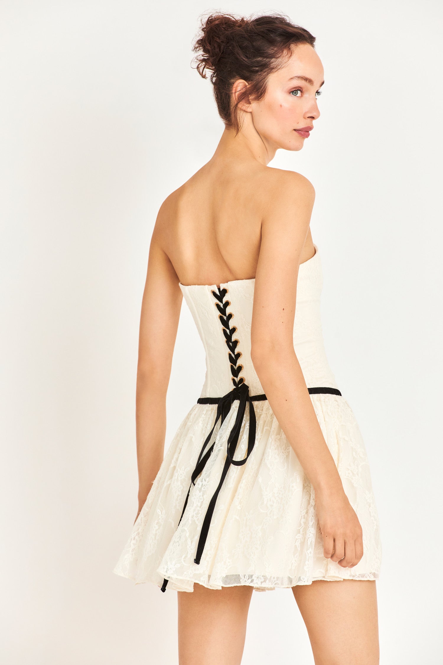 Back image showing lace up detail on white mini dress