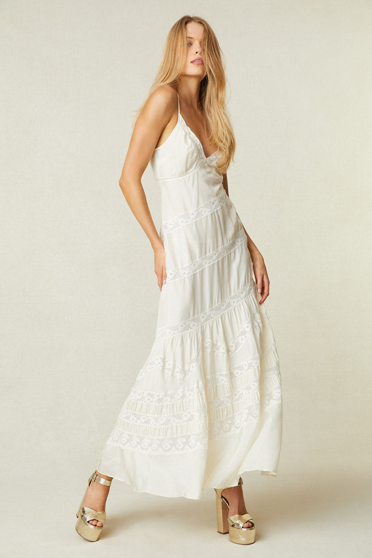 Model wearing white maxi silk dress with lace detail