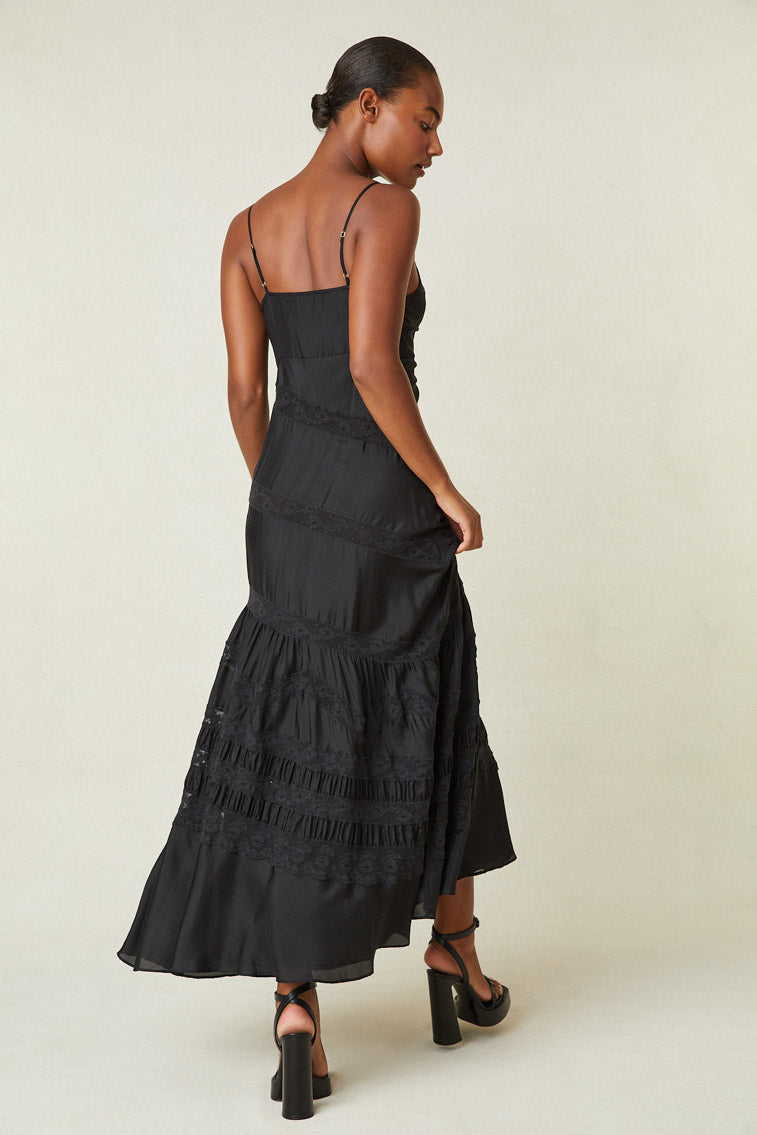 Back image of model wearing black maxi silk dress with lace detail