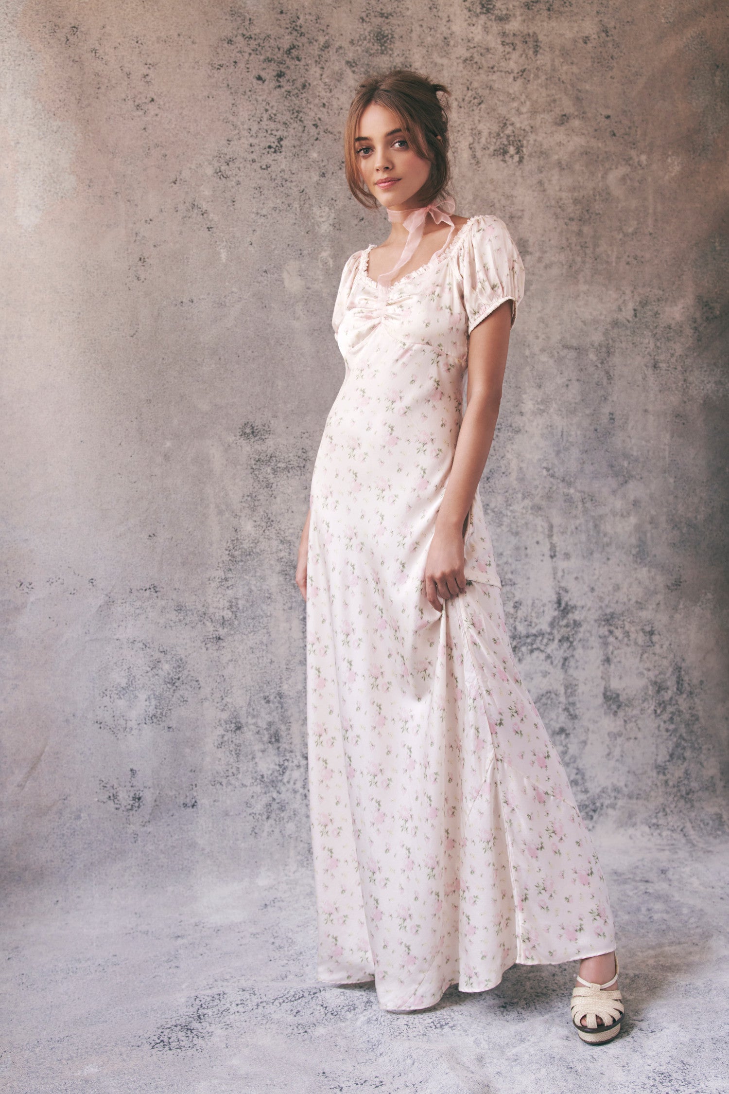 model wearing cream floral maxi dress
