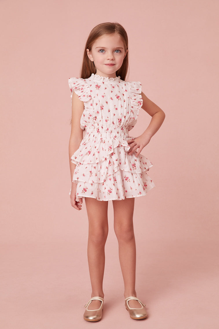 Frock in floral print, has a ruffle-trimmed collar, buttons down center front, flutter sleeves, an elastic waist and overlapping asymmetrical ruffles at the skirt.