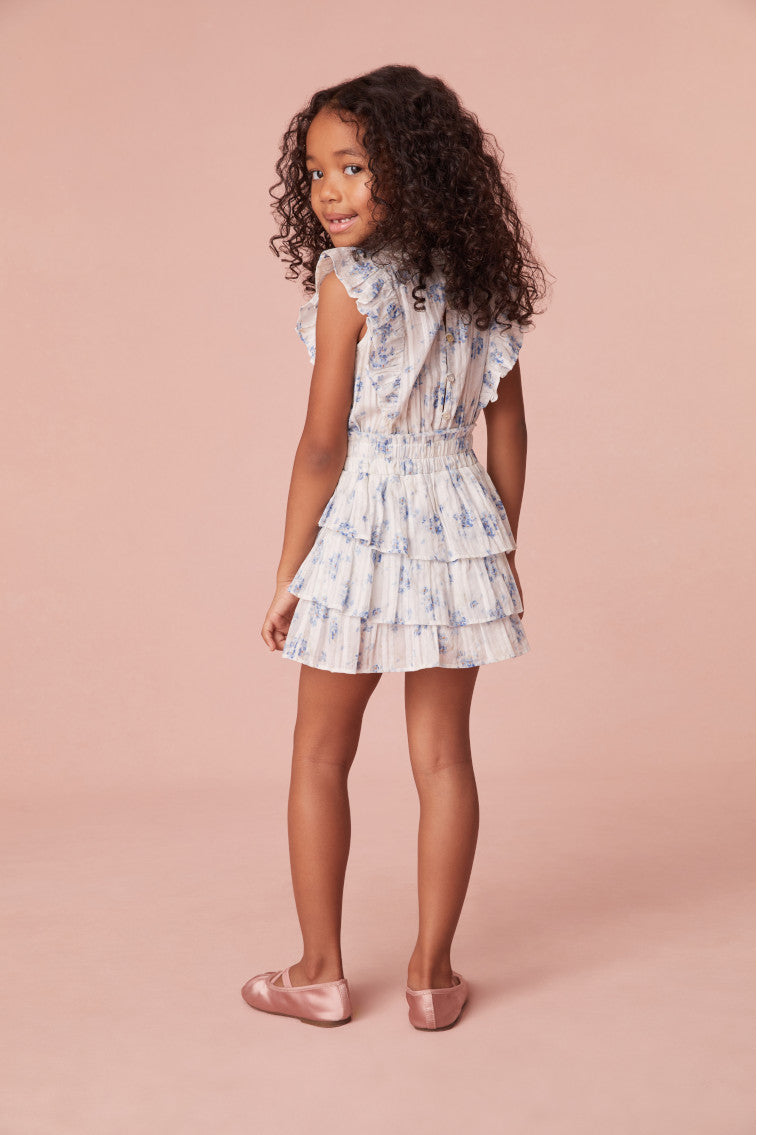 Girls frock in a new dreamy blue floral print, has a ruffle-trimmed collar, buttons down center front, flutter sleeves, an elastic waist and overlapping asymmetrical ruffles at the skirt.