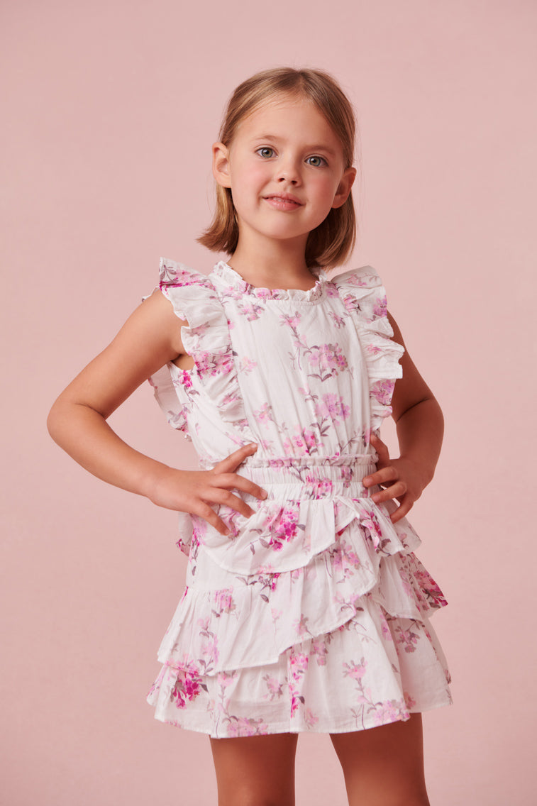 Frock dress with a ruffle-trimmed collar, buttons down center front, flutter sleeves, an elastic waist and overlapping asymmetrical ruffles at the skirt.