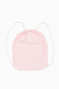 Pink drawstring bag with white polka dots on a white background