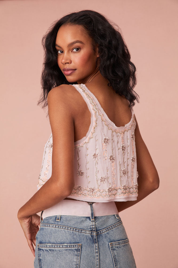 Swing crop top featuring embroidery and embellished beading all over in a zig zag pattern with stars. Has a subtle trim of chiffon around the neckline.