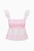 Pink top with white lace details on a white background