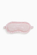 Pink eye mask with lace details on a white background