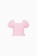 Pink patterned top on a white background