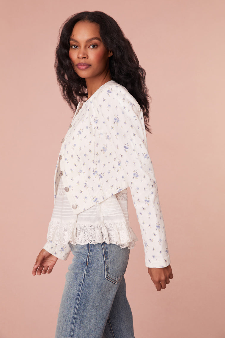 Cropped, white denim jacket featuring a pocono ikat floral print. Includes a cut-out detail on the front and custom LoveShackFancy logo buttons.