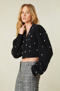 weater features pearl and crystal embellishments all over the front and the long blouson sleeves