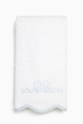 White towel with blue embroidery on a white background