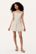 Girl wearing a white floral dress on a white background