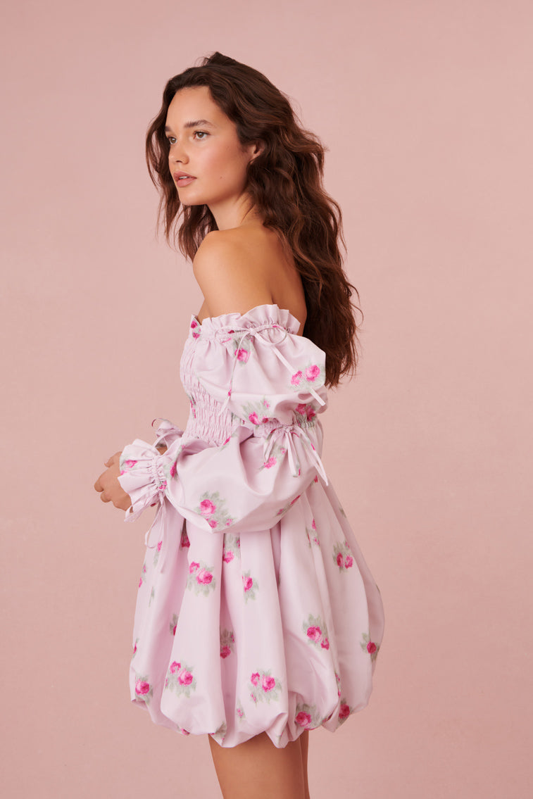 Bubble mini dress features a smocked bodice, pockets, and a puff sleeves.
