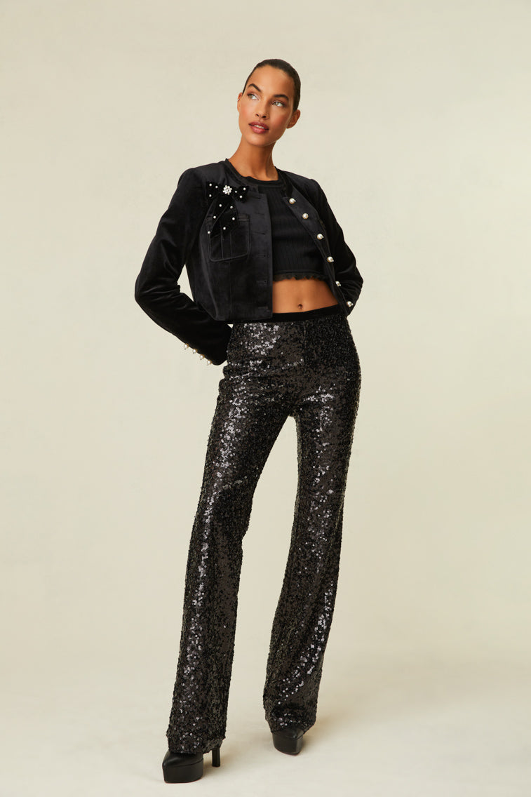 Sequin pants are a straight leg with a mid-rise fit and features a side zipper. 
