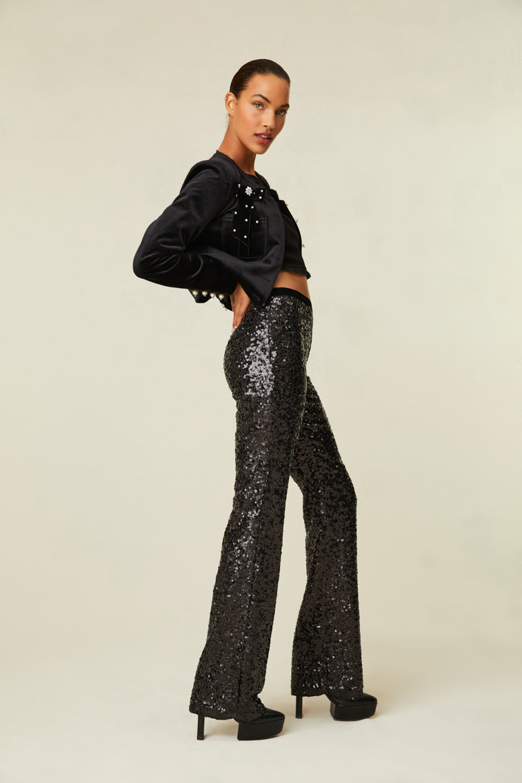 Sequin pants are a straight leg with a mid-rise fit and features a side zipper.