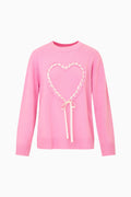 Pink sweater with a heart design on a white background
