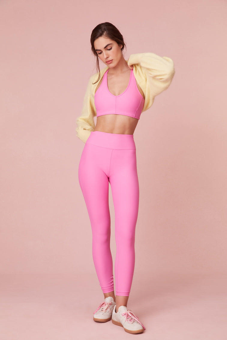 Pink high-waisted leggings with a sleek style and feature a smocked waistband for a seamless performance. 