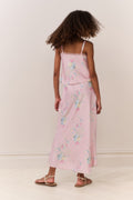 Tween wearing a pink floral skirt and top against a white background