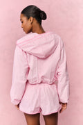 Person wearing a pink textured outfit on a pink background
