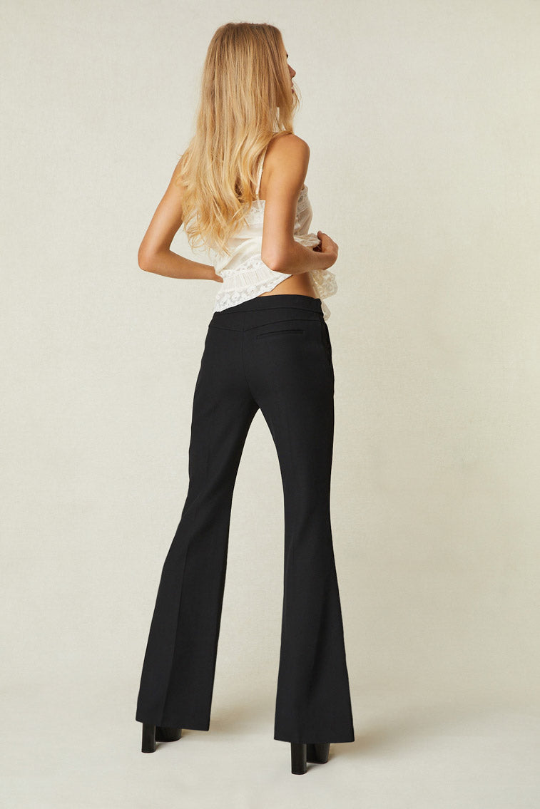 Model wearing black flare trouser pants