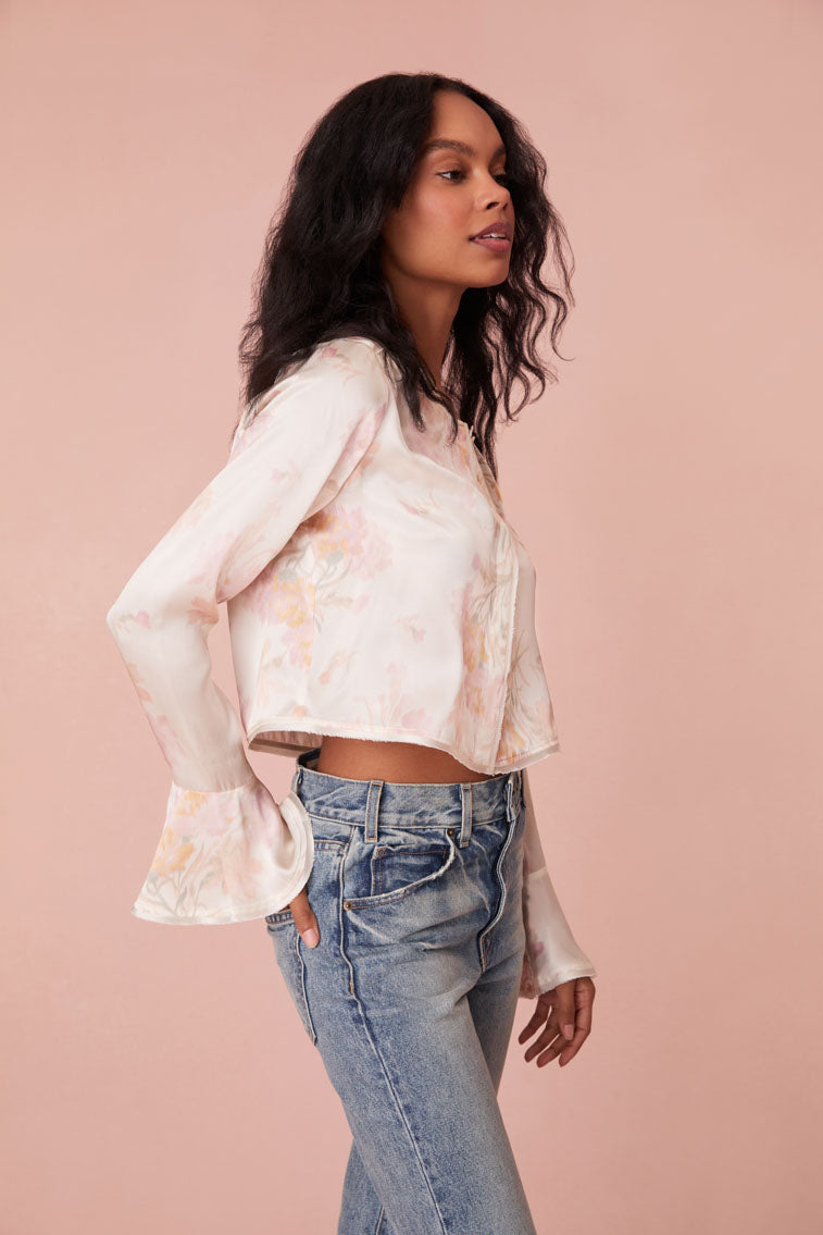 Floral top with long bell sleeves and our custom LoveShackFancy buttons down center front.