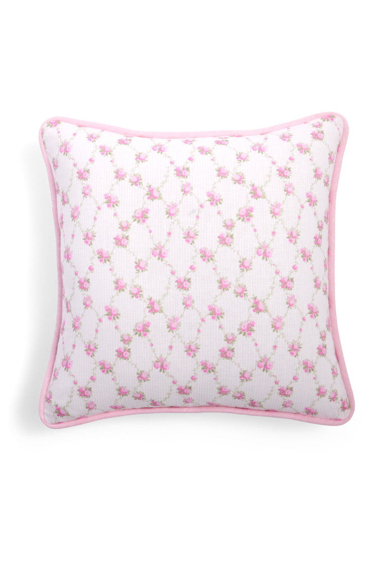 White throw pillow with a tiny pink floral print.