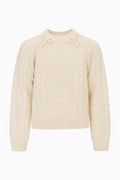 Tween Mavita cable-knit pullover sweater in cream with crew neck, long sleeves, and bow details at the neckline